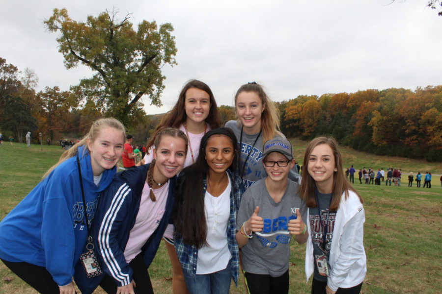 Members+of+the+cross+country+team+gather+for+a+photo+at+a+late+season+meet.+Photo+by+Alyssa+Griffith.