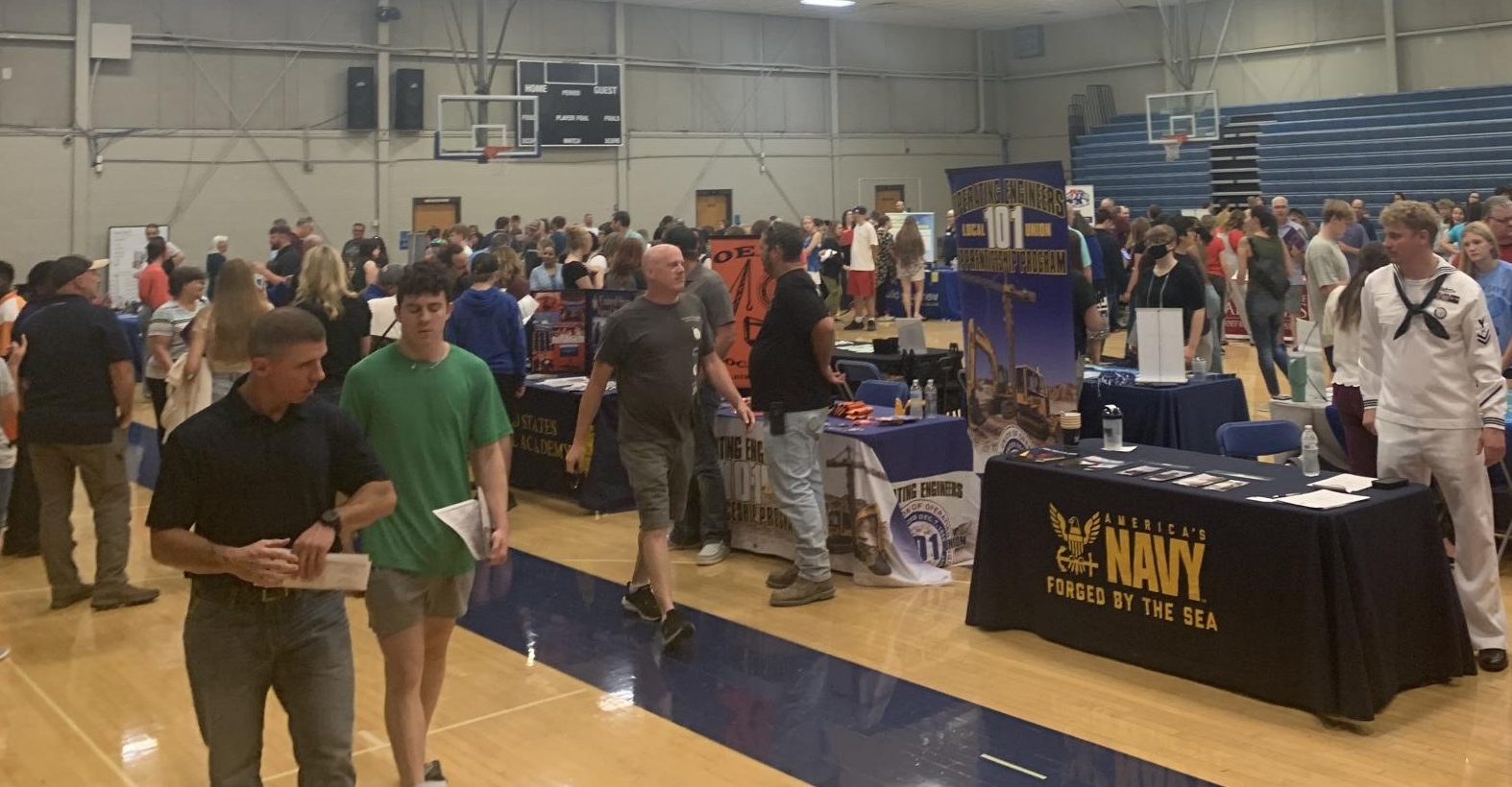 Students crowding around each college booth in Cokley gym during the LPS college fair on Sept. 12.