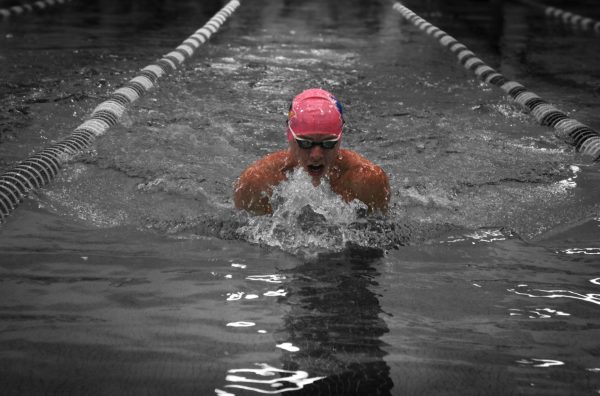 The men's swim coach celebrates how well his team performs in these upcoming swim meets. He also praised his team for how they performed last year.  “The nice part about this team is we have a lot of guys who are very fast and performed well at state last year,” Coach Murphy said. Photo by Iyari Hyde.