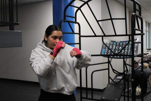 Sophomore Marisol Flores expresses herself about how boxing impacts her life. She shared that she gained so many exciting experiences with boxing. “How I've met a lot of people that have been good mentors to me, and how I've had opportunities that I wouldn't have had without boxing,” Flores said. Photo by Iyari Hyde.