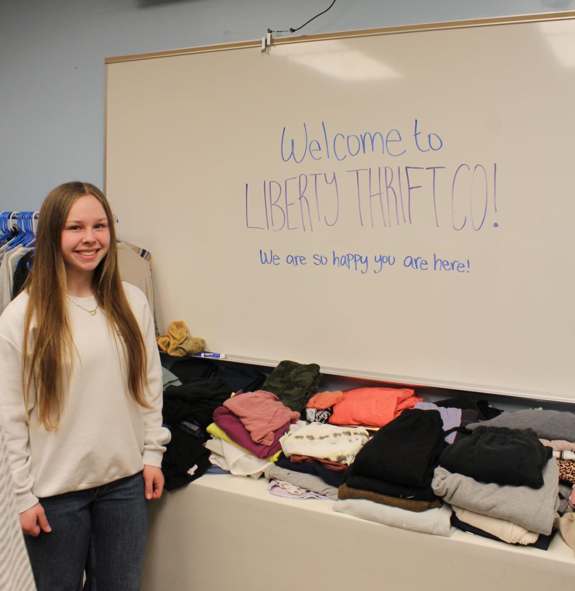 Senior Ella Anderson runs the thrift store associated with Key Club during the first hour. They use donated materials given to them like prom dresses. “My favorite part of the thrift store is our section of dresses and jeans because there are so many options,” Anderson said. Photo by Gracee Peugh.