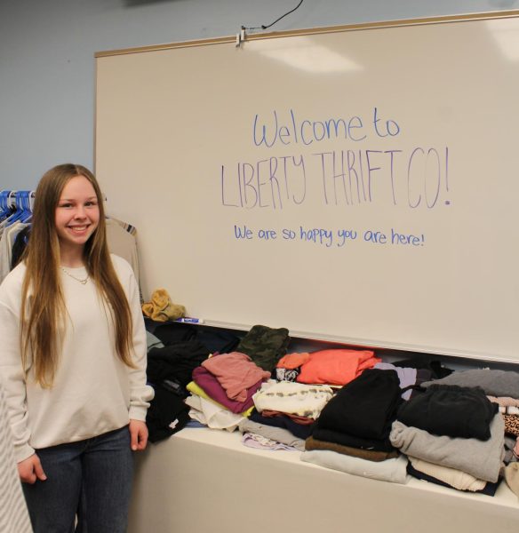Senior Ella Anderson runs the thrift store associated with Key Club during the first hour. They use donated materials given to them like prom dresses. “My favorite part of the thrift store is our section of dresses and jeans because there are so many options,” Anderson said. Photo by Gracee Peugh.